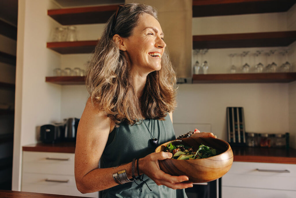 Women-in-Kitchen-with-healthy-Food-bowl